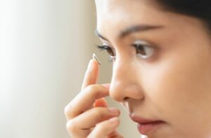 A scleral contact lens wearer inserting their lenses for the day