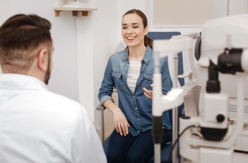 A patient smiles while talking to their optometrist about intense pulsed light (IPL) treatment for dry eye.